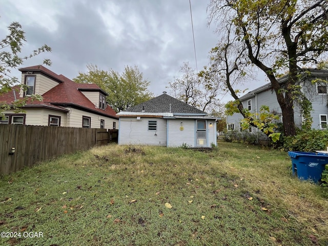 back of house with a yard