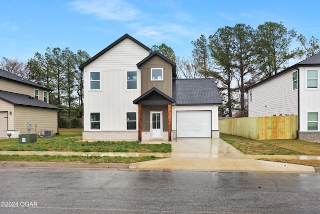 view of front of house featuring central AC unit and a garage