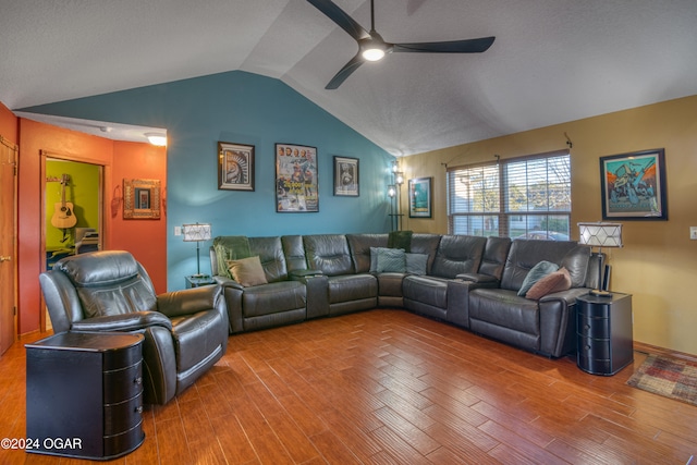 living room with hardwood / wood-style floors, vaulted ceiling, and ceiling fan