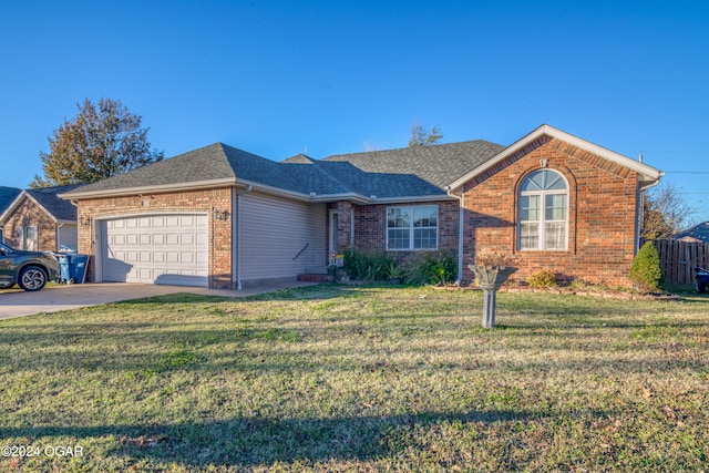 ranch-style home with a front yard and a garage