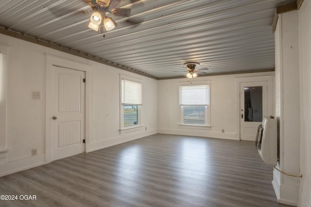 319-323 N Harlem Ave, Joplin, MO 64801 - spare room with ceiling fan, heating unit, dark wood-type flooring, and baseboards