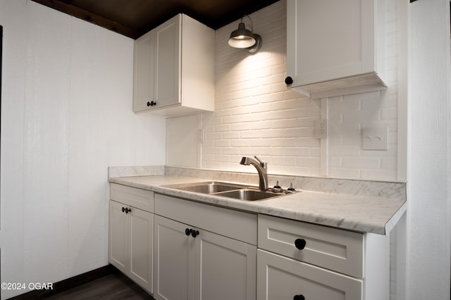 319-323 N Harlem Ave, Joplin, MO 64801 - kitchen with a sink, decorative backsplash, light countertops, and white cabinets