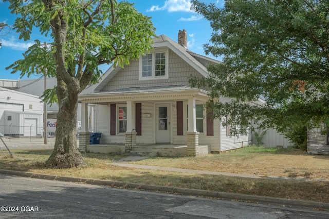 319-323 N Harlem Ave, Joplin, MO 64801 - view of front of property with a chimney and covered porch