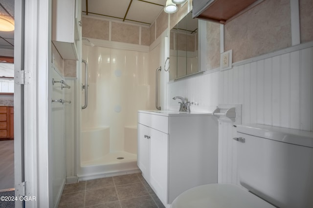 319-323 N Harlem Ave, Joplin, MO 64801 - full bathroom with a stall shower, vanity, toilet, and tile patterned floors