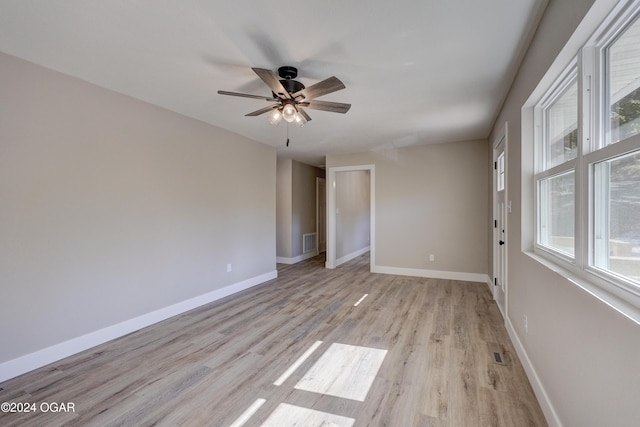 empty room featuring ceiling fan and light hardwood / wood-style flooring