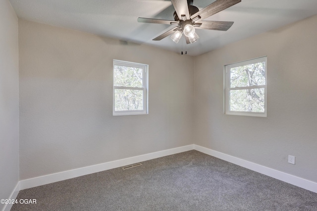 spare room featuring carpet flooring, plenty of natural light, and ceiling fan