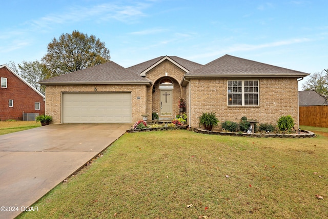 single story home with central AC, a front lawn, and a garage