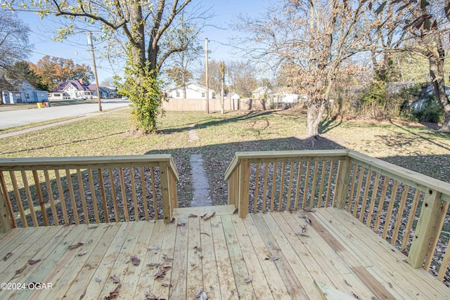 wooden deck featuring a yard