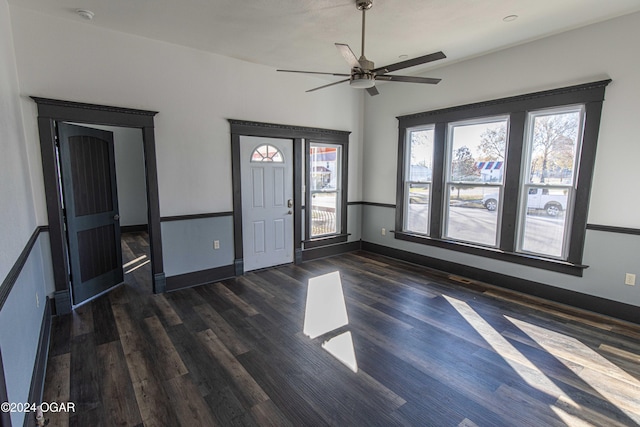 foyer entrance with ceiling fan and dark hardwood / wood-style flooring