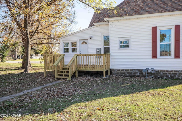 back of house with a yard and a deck