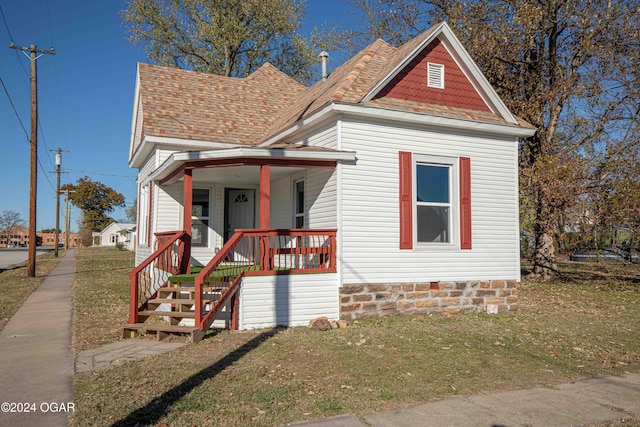 view of front of house with a front lawn and a porch