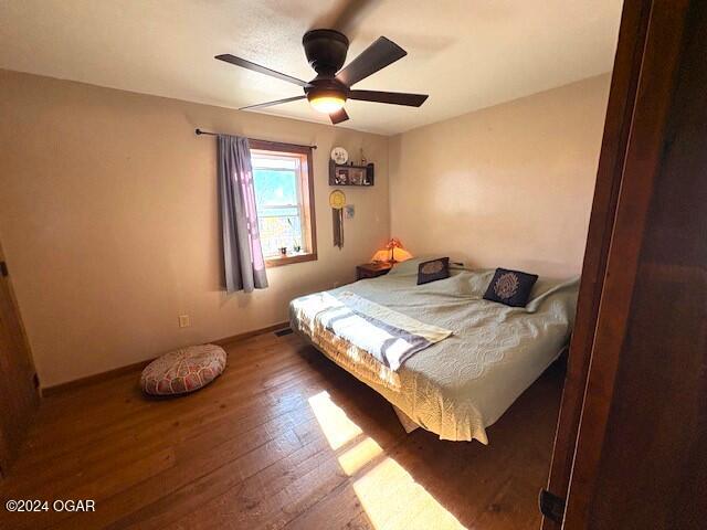 bedroom featuring hardwood / wood-style flooring and ceiling fan