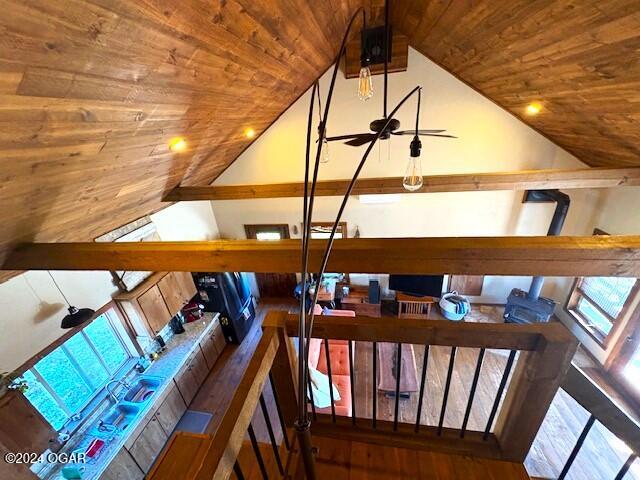 stairs with hardwood / wood-style floors, vaulted ceiling, and wooden ceiling