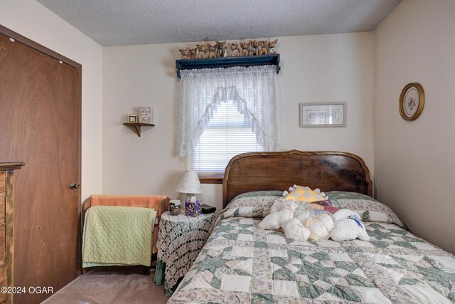 bedroom featuring a textured ceiling and carpet floors