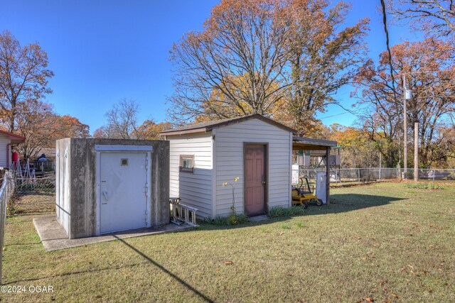 view of outdoor structure featuring a lawn