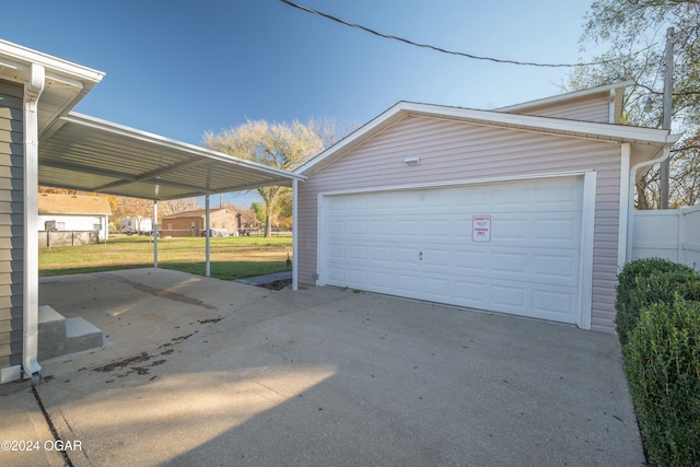 garage with a yard and a carport