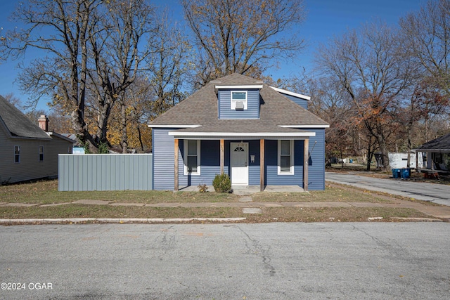 bungalow with a porch and a front yard