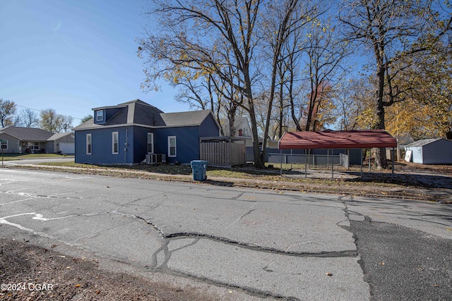 view of property exterior with a shed and a carport