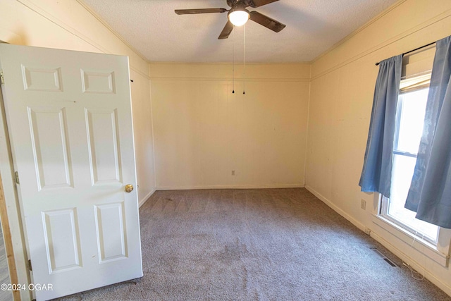 carpeted empty room with a textured ceiling and ceiling fan