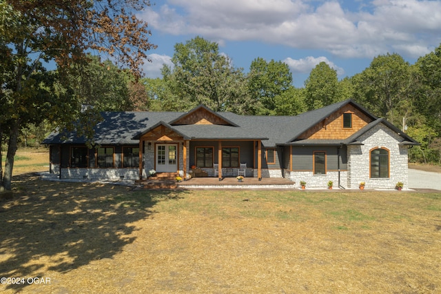 view of front of property with a porch and a front yard