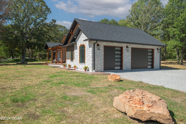 view of side of property featuring a lawn and a garage