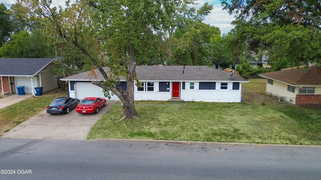 single story home with a garage and a front lawn