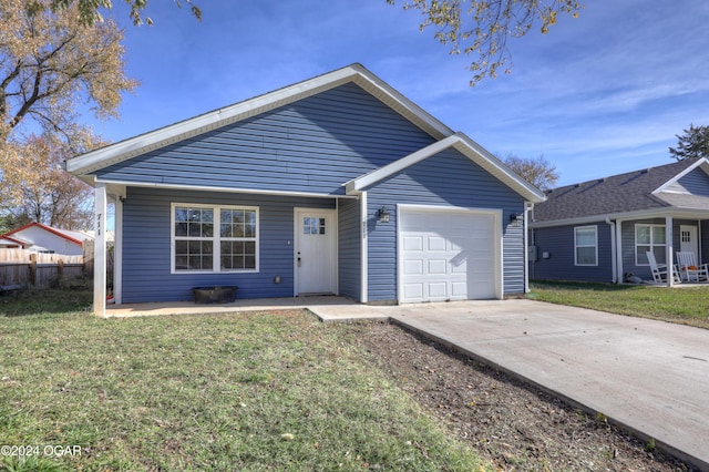 view of front of home featuring a front yard and a garage