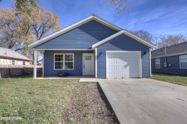 view of front of home with a garage and a front lawn