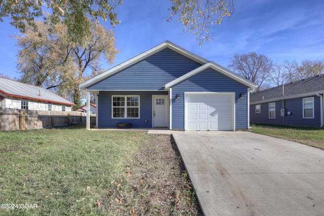 ranch-style home with a garage and a front lawn