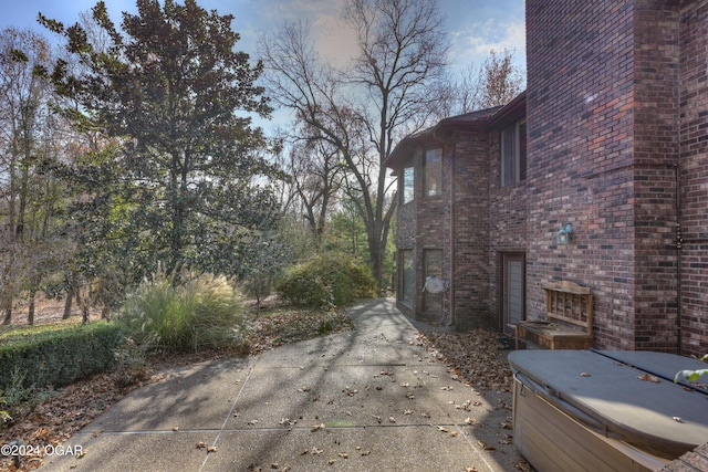 5623 Rivercrest Valley Dr, Joplin, MO 64804 - view of side of home featuring a hot tub and brick siding
