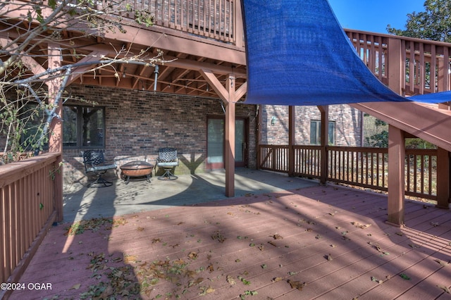5623 Rivercrest Valley Dr, Joplin, MO 64804 - wooden terrace with a fire pit