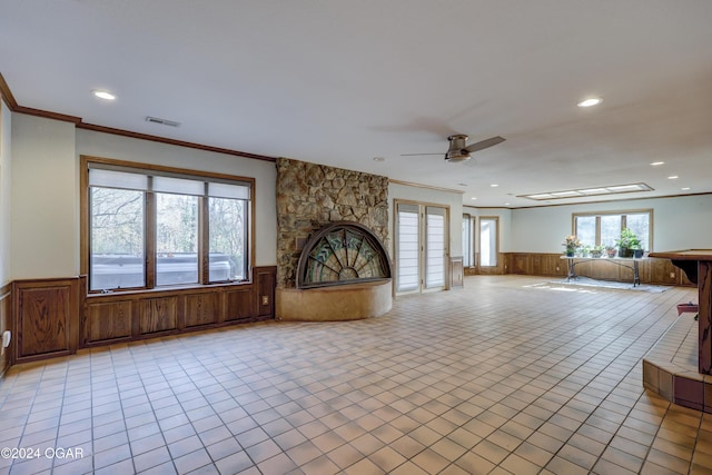 5623 Rivercrest Valley Dr, Joplin, MO 64804 - unfurnished living room with a wainscoted wall, ceiling fan, recessed lighting, crown molding, and light tile patterned flooring