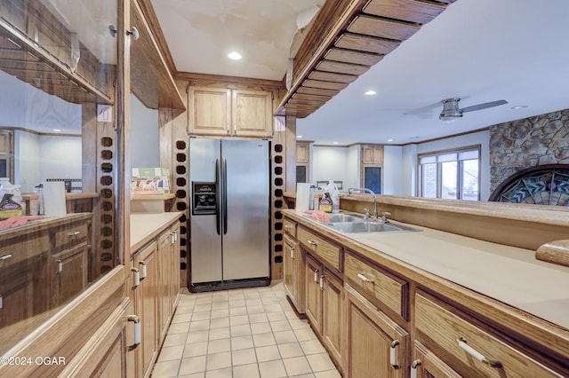 5623 Rivercrest Valley Dr, Joplin, MO 64804 - kitchen featuring stainless steel refrigerator with ice dispenser, light tile patterned floors, light countertops, a ceiling fan, and a stone fireplace