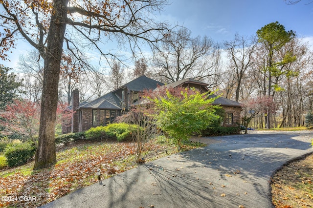 5623 Rivercrest Valley Dr, Joplin, MO 64804 - view of property exterior featuring asphalt driveway and a chimney