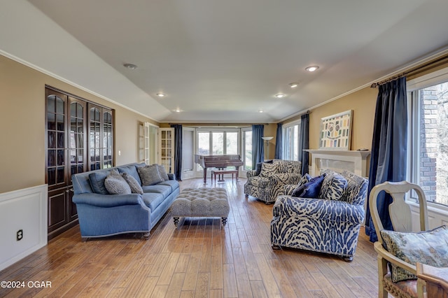 5623 Rivercrest Valley Dr, Joplin, MO 64804 - living room featuring crown molding, healthy amount of natural light, hardwood / wood-style floors, wainscoting, and recessed lighting