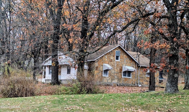 view of home's exterior with a lawn