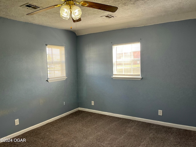 carpeted empty room with a textured ceiling and ceiling fan