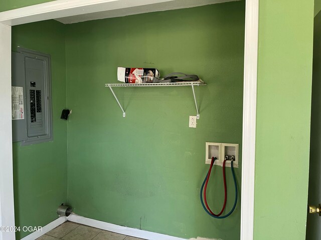 laundry room with hookup for a washing machine, electric panel, and light tile patterned flooring