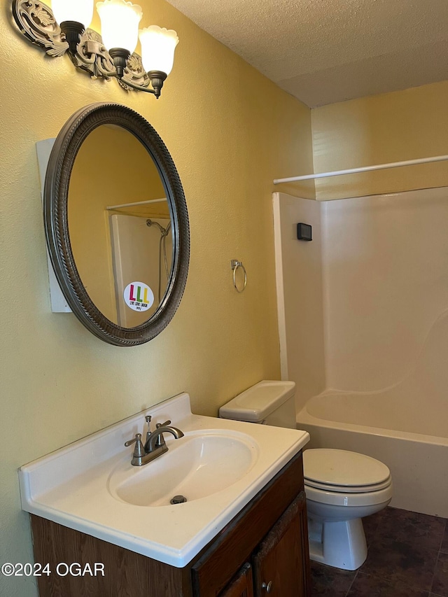 full bathroom featuring washtub / shower combination, vanity, a textured ceiling, and toilet