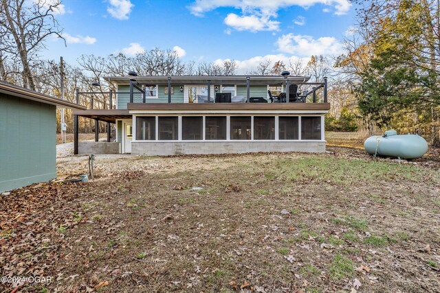 rear view of house featuring a sunroom