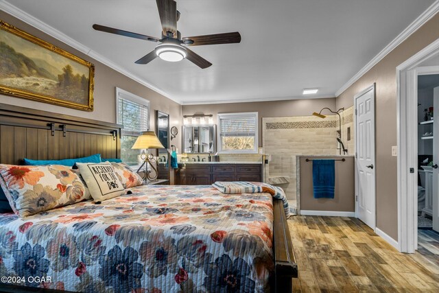 bedroom featuring crown molding, light wood-type flooring, and ceiling fan