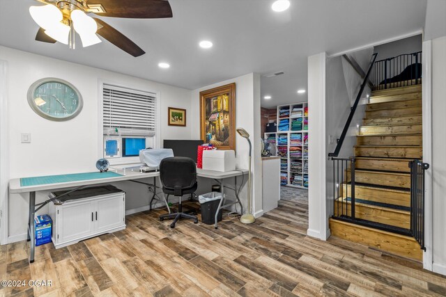 office space with light hardwood / wood-style floors and ceiling fan