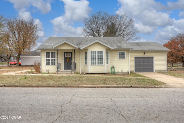 single story home featuring a garage and a front lawn