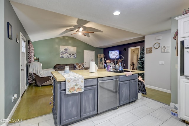 kitchen with gray cabinetry, dishwasher, sink, light hardwood / wood-style flooring, and vaulted ceiling