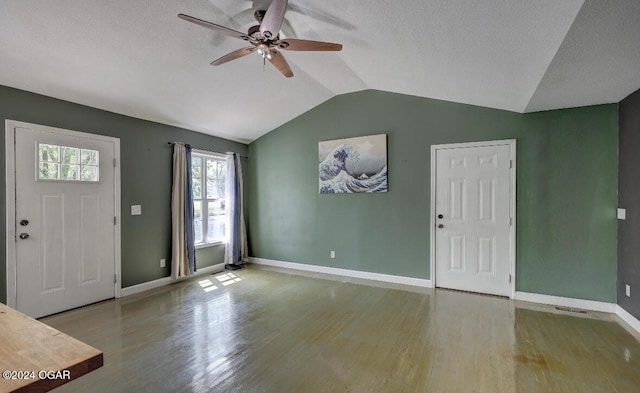 entryway featuring a textured ceiling, ceiling fan, hardwood / wood-style floors, and lofted ceiling