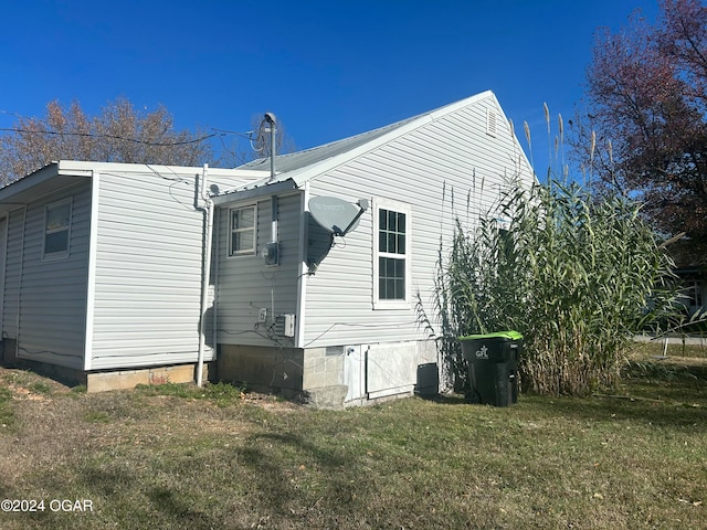 back of property featuring a yard