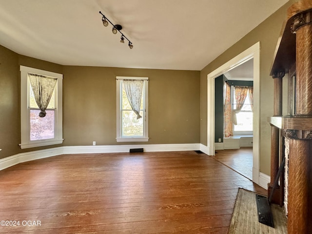 interior space featuring hardwood / wood-style floors and rail lighting