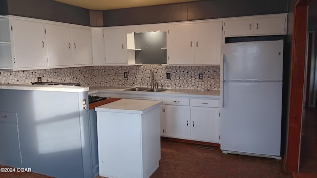 kitchen featuring tasteful backsplash, sink, white cabinets, and white refrigerator