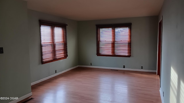 spare room featuring light hardwood / wood-style flooring