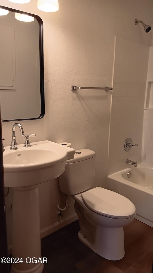 full bathroom with wood-type flooring,  shower combination, toilet, and sink